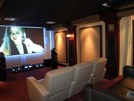 Cinema featuring a Sony projector, Stewart screen, KEF speakers, DMF lighting, powered by Crestron Home.