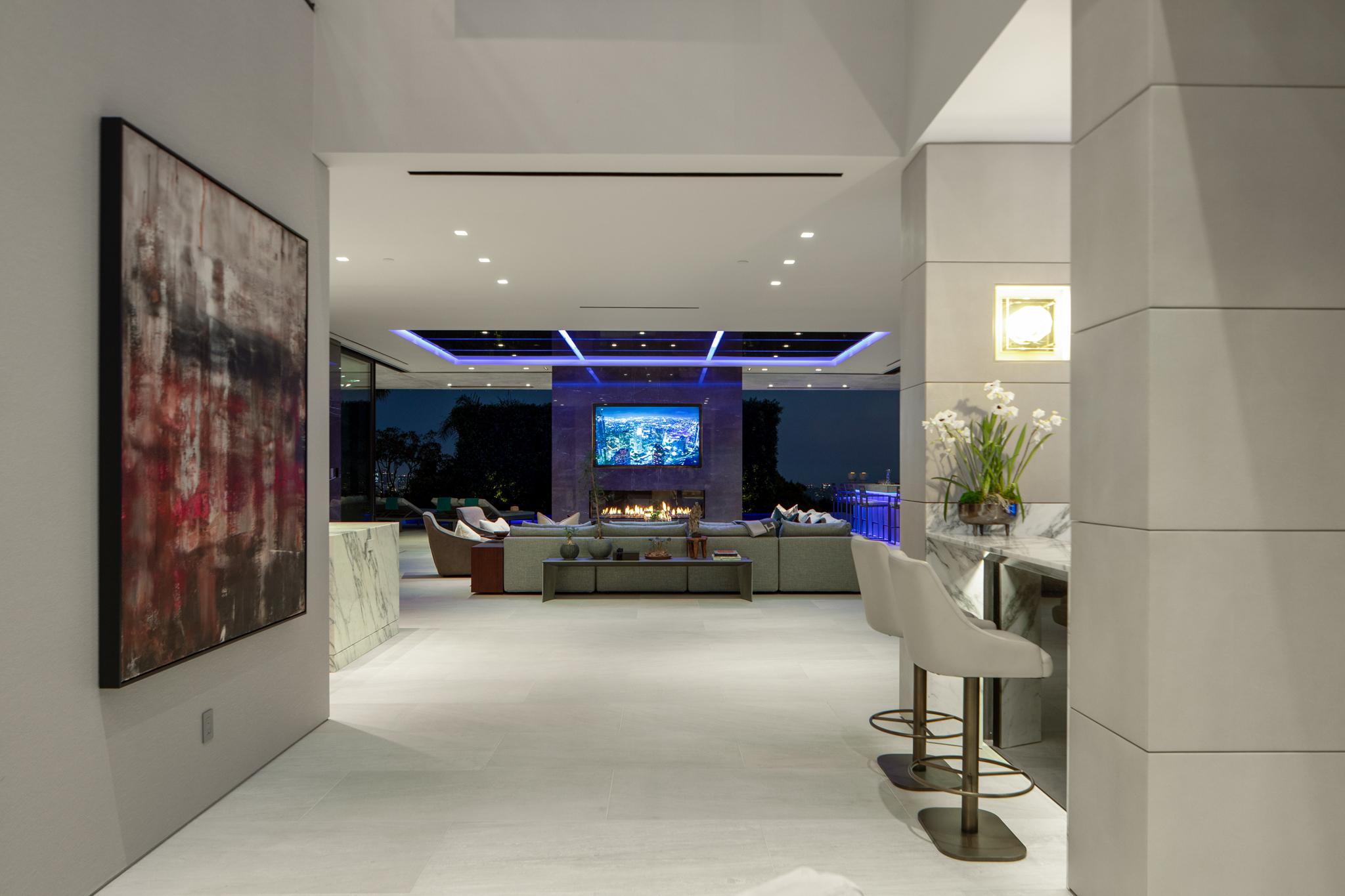Colorbeam Lighting Recessed downlights and RGBWW tape light across an open-plan living space.