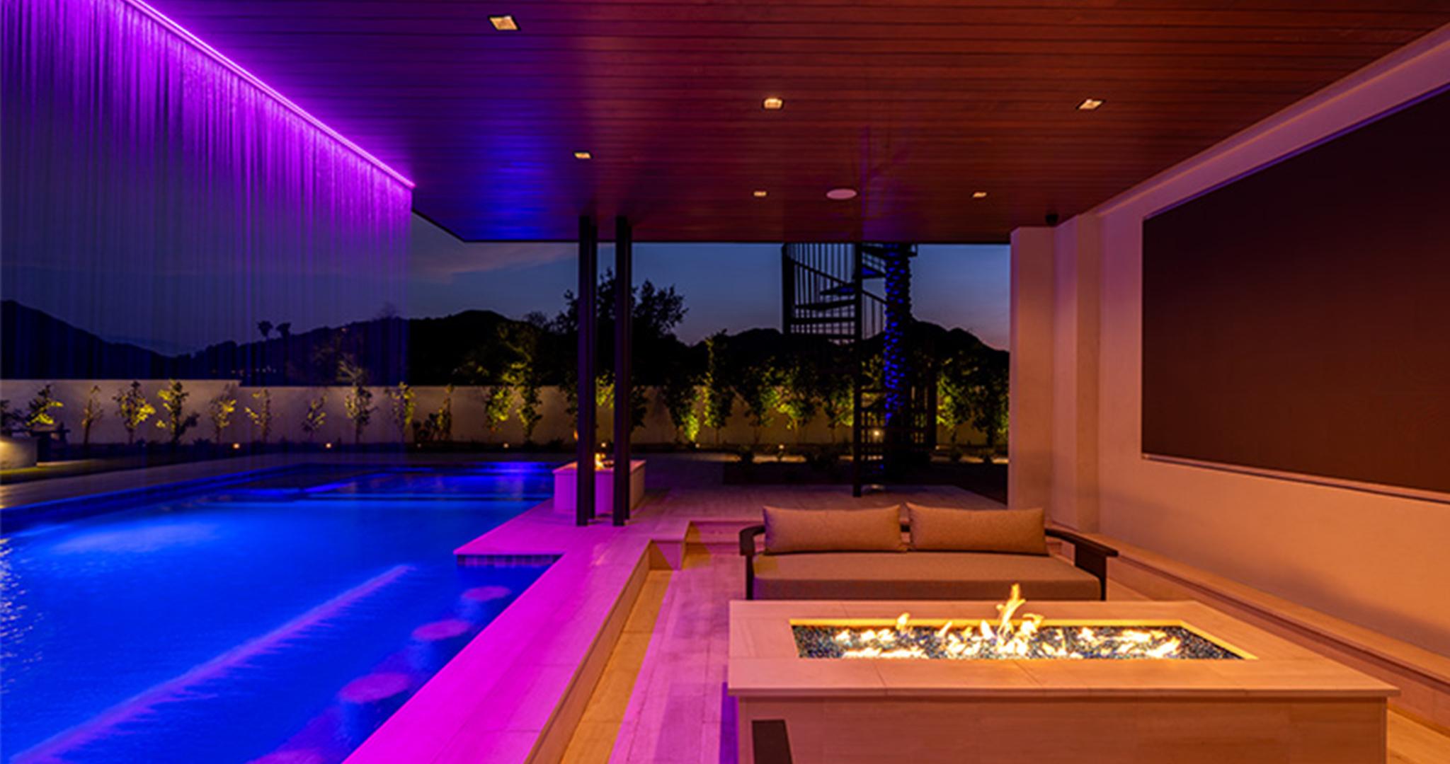 FX Luminaire FX Luminaire transforms this poolside retreat with vibrant LED lighting, blending color, control, ambiance.