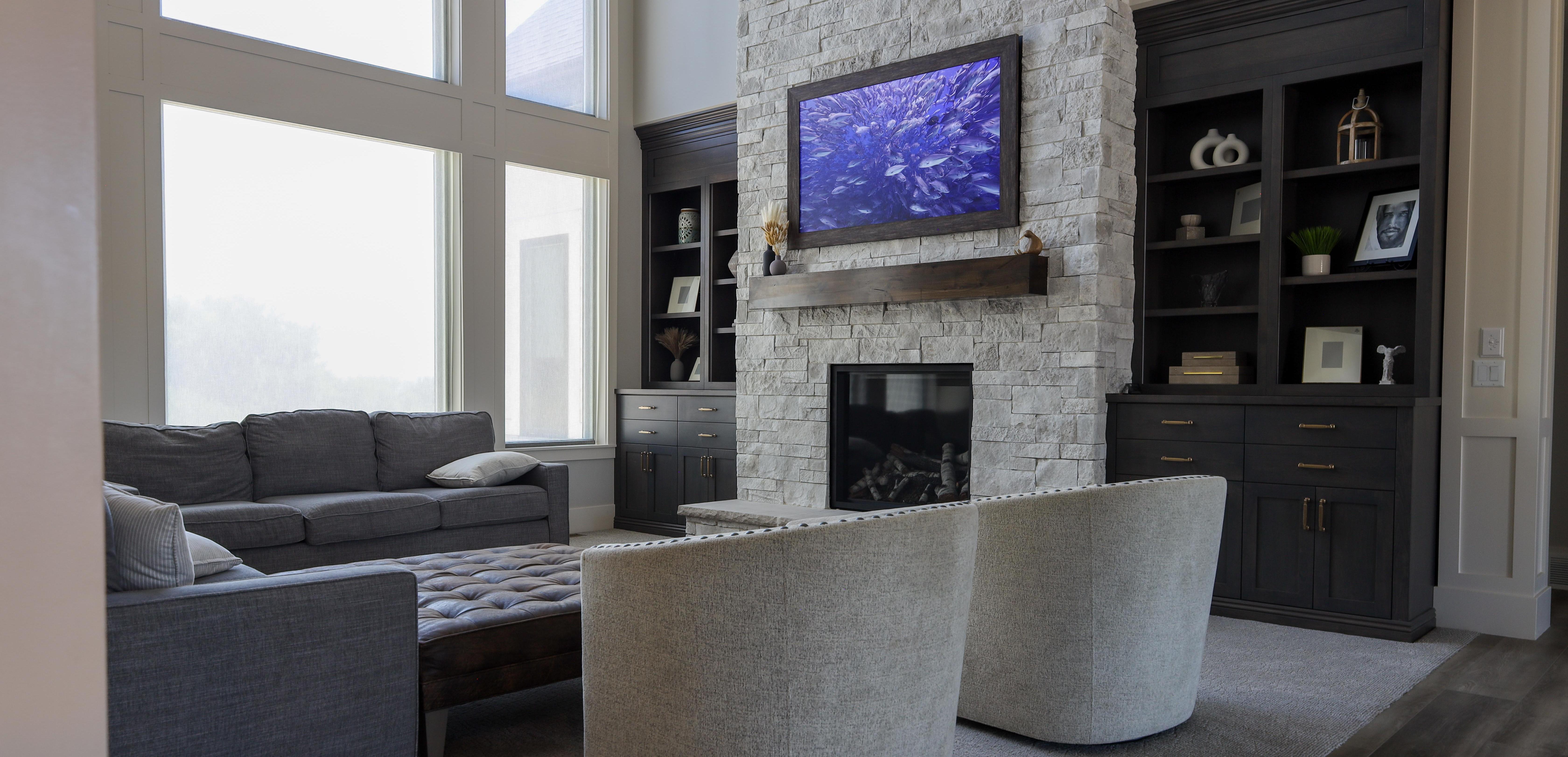 Advanced Integrated Systems Featured in this room are 2 Sonance invisible speakers above the bookshelves on both sides of the fire place.