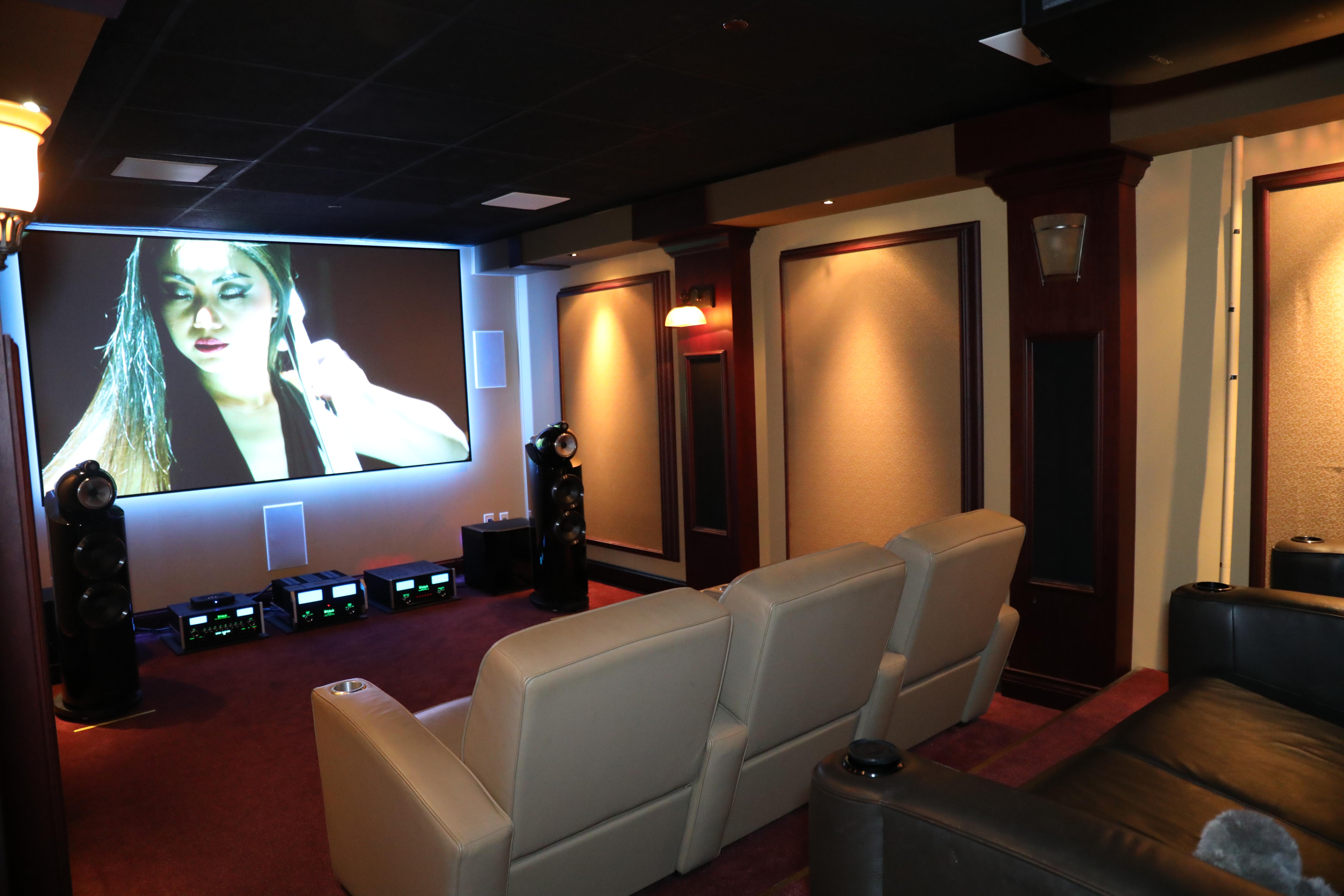 Hippo's Cinema featuring a Sony projector, Stewart screen, KEF speakers, DMF lighting, powered by Crestron Home.