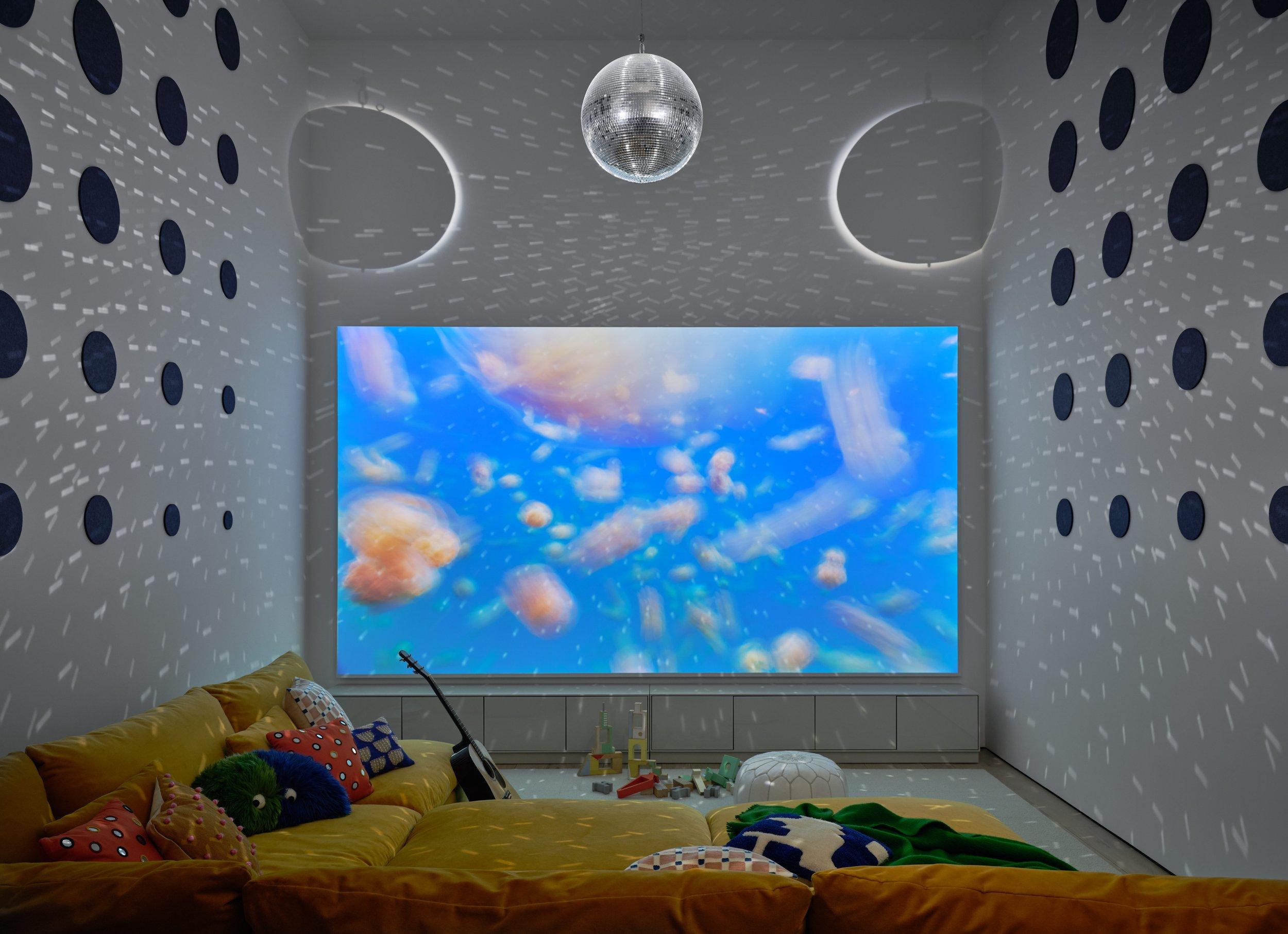 Cravtsman 186" diagonal acoustically transparent screen with 4k projector. 2 subwoofers, and 3 speakers behind it.