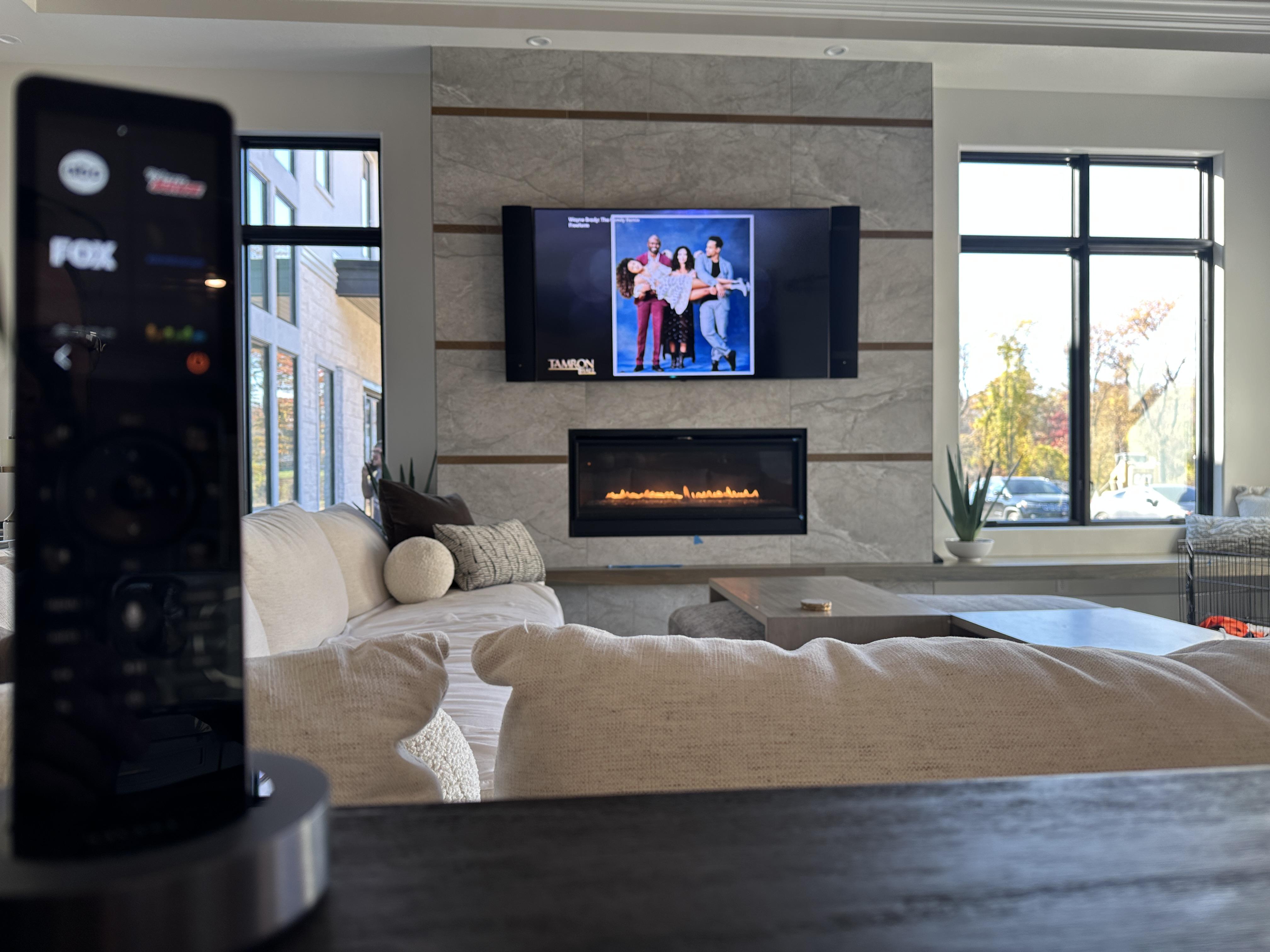KOZI MEDIA DESIGN A Family Room highlighting a custom soundbar to match the TV, and surround provided with invisible speakers.