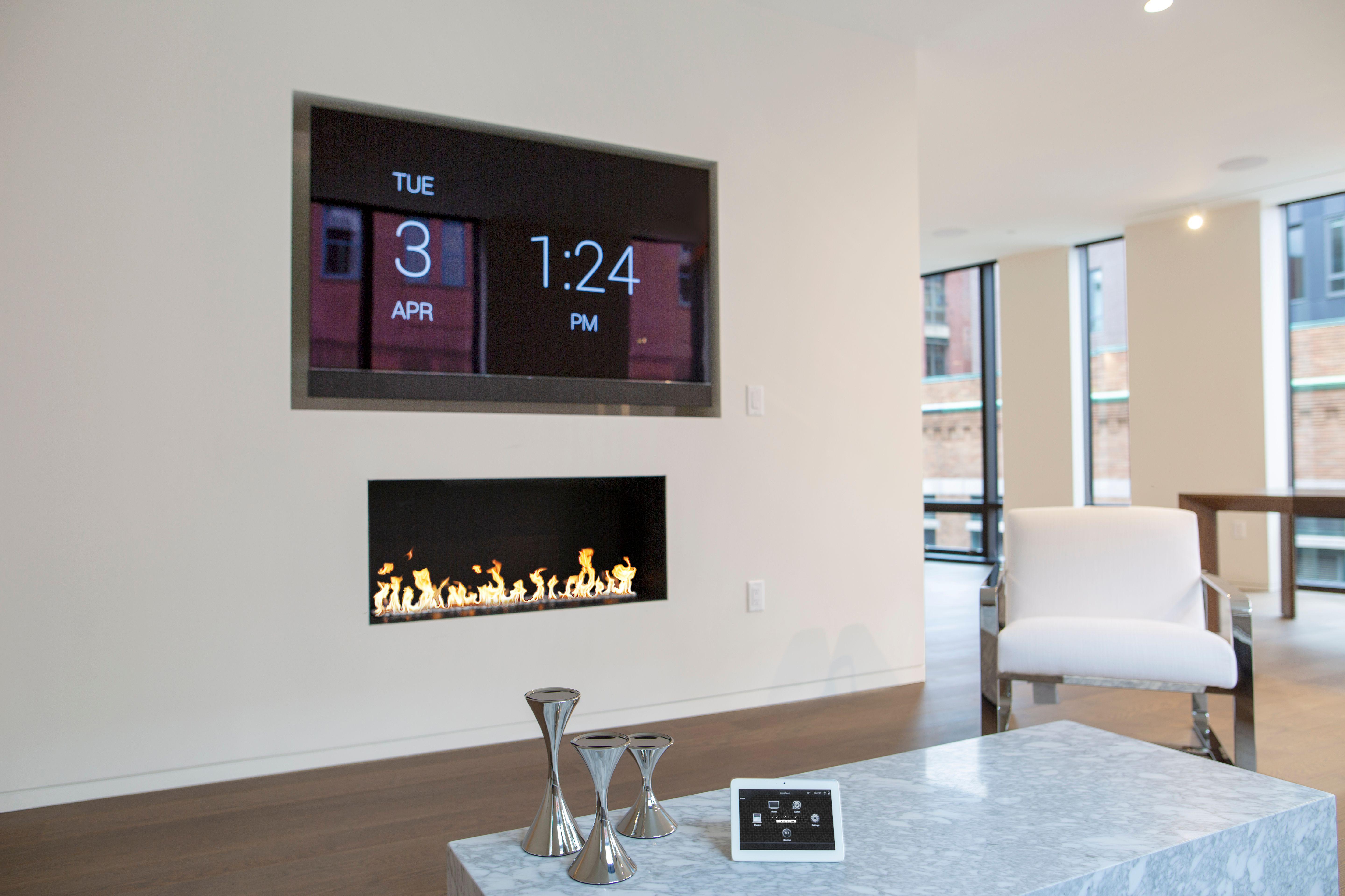 PREMIERE SYSTEMS DESIGN At our client’s ultra-luxury condo in Boston, we integrated a recessed 75” Sony TV and custom Triad soundbar.
