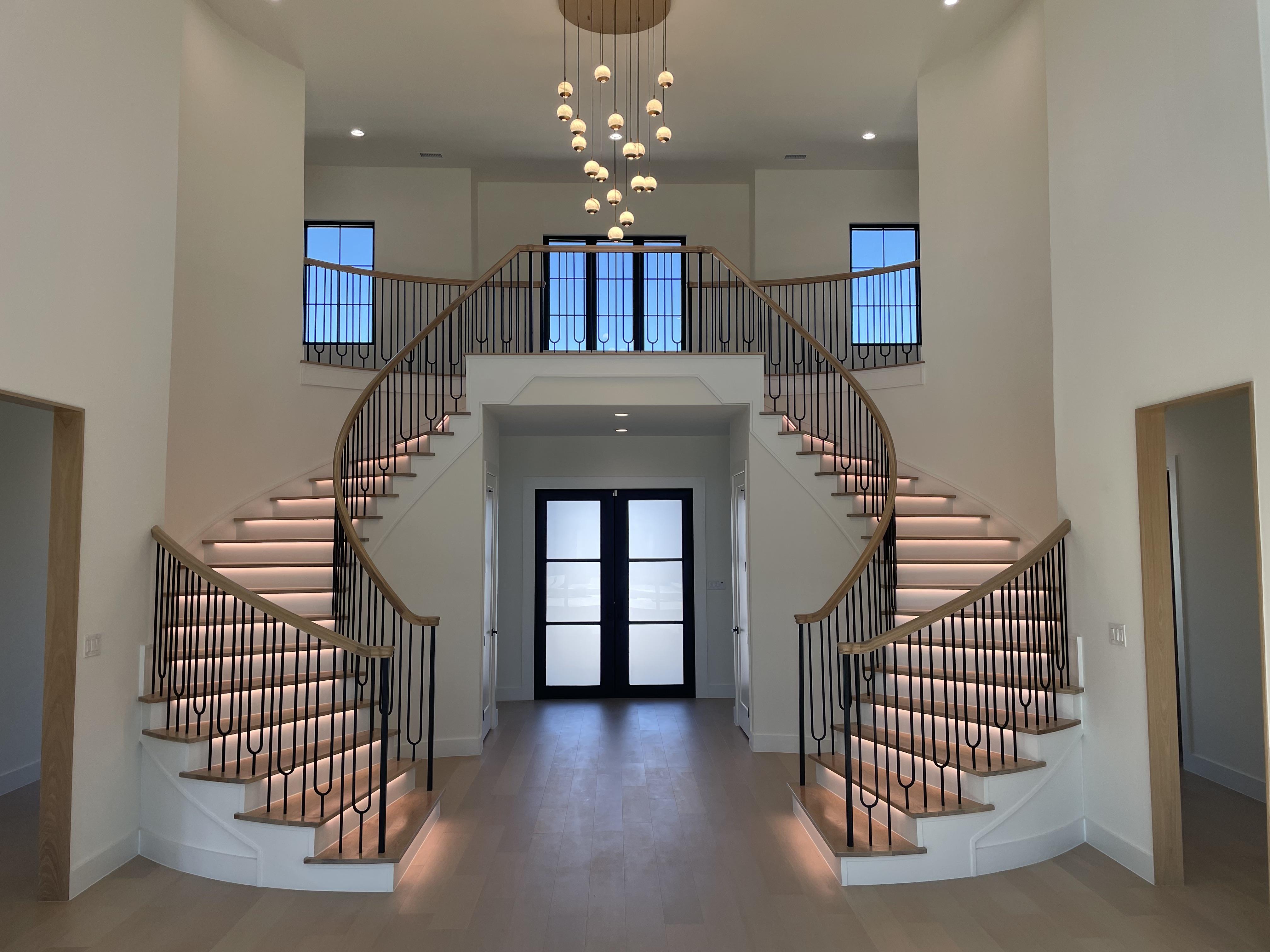 Thoughtful Integrations  ValiantX Warm-Dim Tape light routed into all the stair treads. Crestron Home controlling the lights